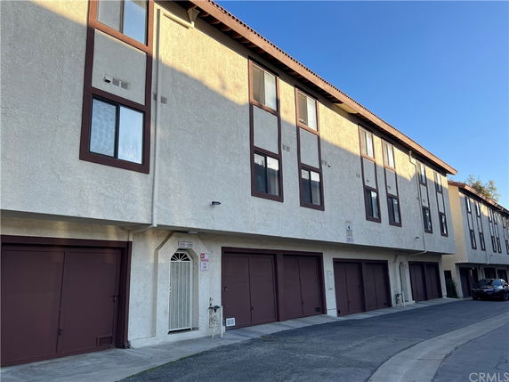Front view of a multi-story building with multiple garage doors.