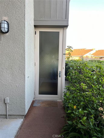 Exterior view of a house entrance with a glass door.