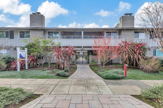 Front view of a two-story building with a pathway leading to the entrance.