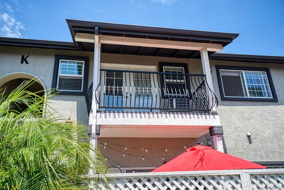 Front view of a two-story house with a small balcony.