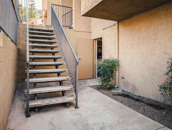Concrete exterior staircase leading to a second level of a building.