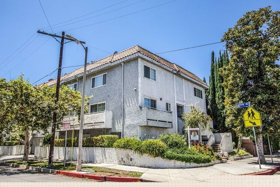 Front view of a multi-story building with a tiled roof.