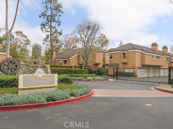 Front view of a residential complex entrance with gated access.