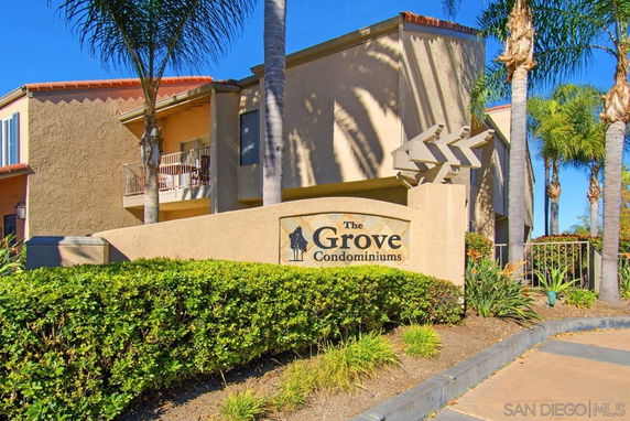 Front view of a condominium building labeled 'The Grove Condominiums'.