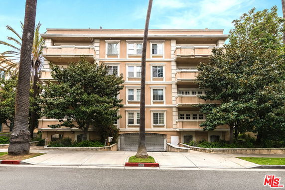 Front view of a multi-story residential building with balconies.