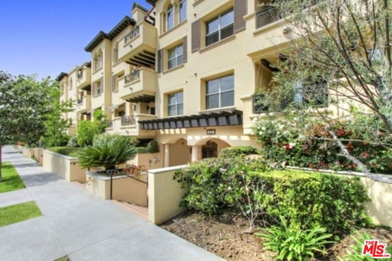 Front view of a multi-story residential building with balconies.