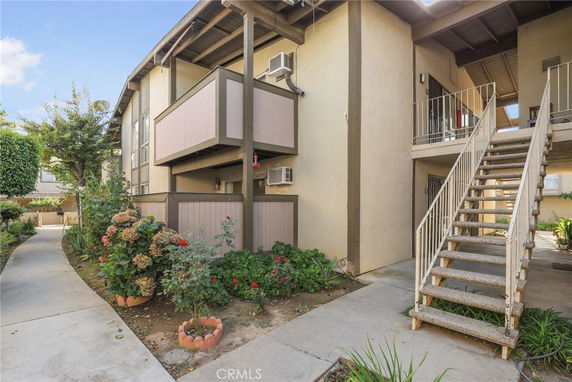 View of a multi-story apartment building with exterior staircases and balconies.