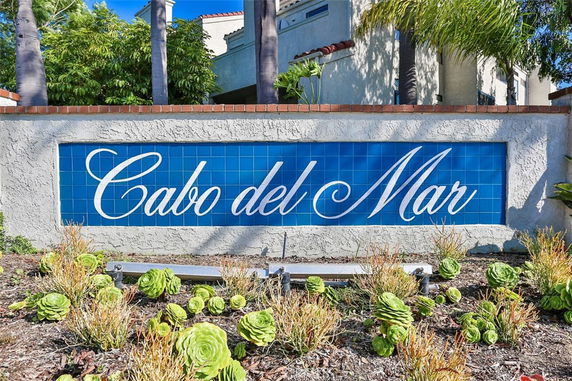 Front view of a building sign with 'Cabo del Mar' displayed on a blue tiled background.