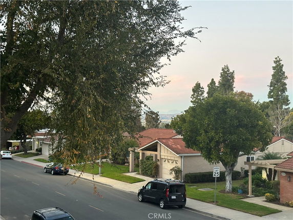 Residential street view with houses and trees.