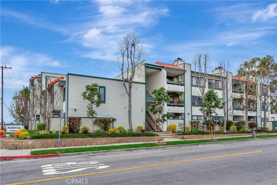Front view of a multi-story residential building with balconies.