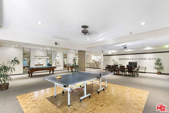 Indoor recreation area with table tennis and billiards tables.