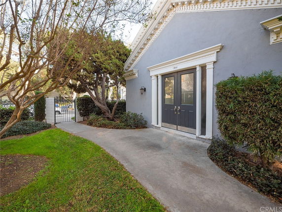 Front view of a building with a double door entrance and decorative trim.