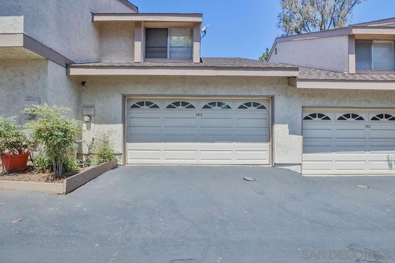 Front view of a townhouse with a double garage.