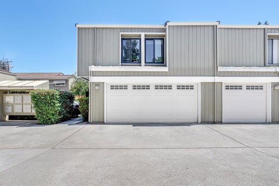 Front view of a two-story building with a double garage.
