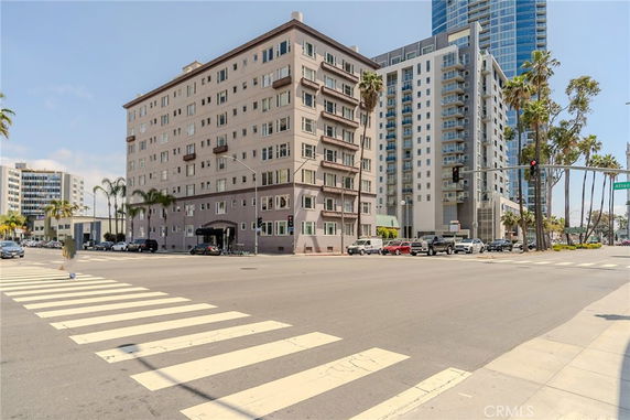 Front view of a multi-story building at a street corner.