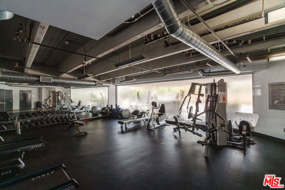 Interior view of a gym with various exercise equipment.
