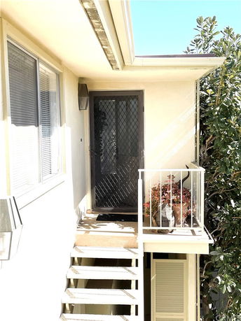 Exterior view of a building with stairs leading to a door