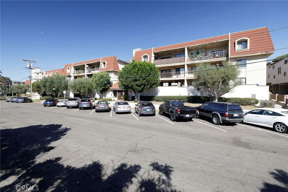 Front view of a multi-story residential building with balconies.