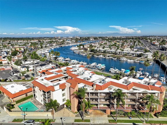Panoramic view of a waterfront residential area with a marina and surrounding neighborhood.