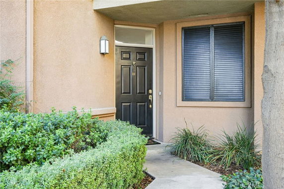 Front view of a house with a black door and window.