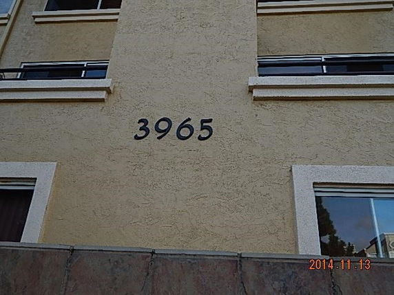 Front view of a building with the number 3965 on the wall.