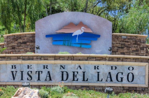 Sign with the text 'Bernardo Vista Del Lago' and a decorative emblem featuring a bird and scenery.
