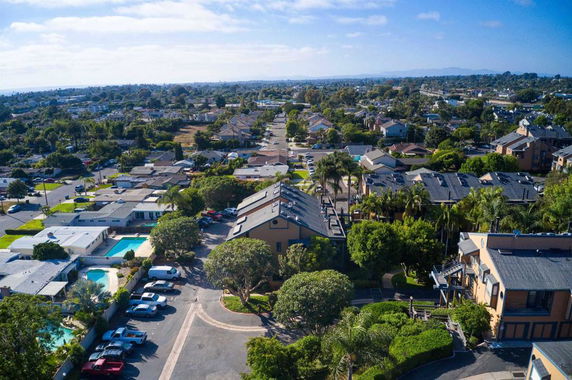 Aerial view of a suburban neighborhood with various houses and buildings.
