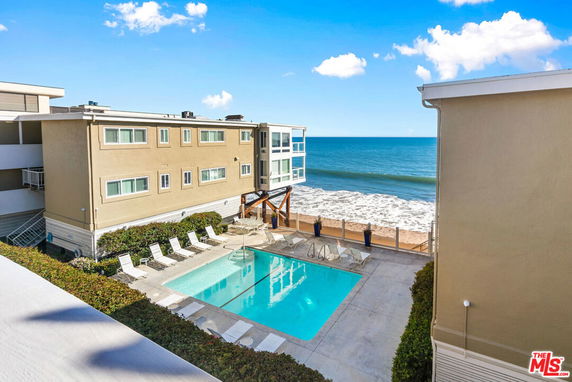 Swimming pool area by the beachfront apartment complex.