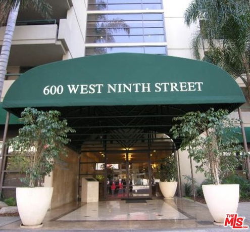 Entrance view of a building with green awning labeled 600 West Ninth Street.