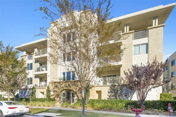 Front view of a multi-story residential building with balconies.