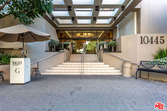 Front view of a building entrance with a staircase and address number 10445.