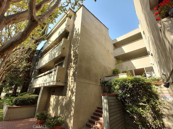 Front view of a multi-story residential building with balconies.