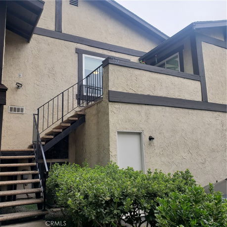 Front view of a multi-story building with stair access.