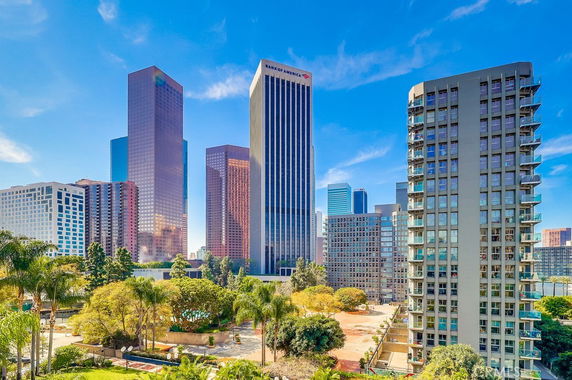 View of tall buildings in a cityscape, showcasing a variety of high-rise structures.