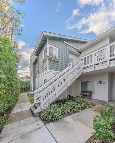 Elevated view of a two-story residential building with an external staircase.