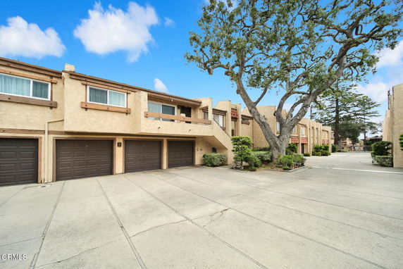 Front view of a two-story residential building with multiple garages.