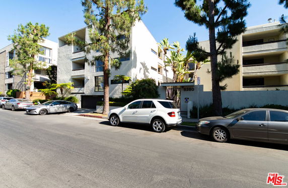Front view of a multi-story apartment building with balconies.
