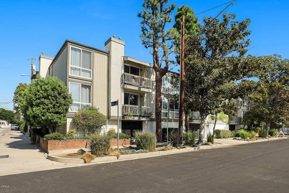 Front view of a multi-story residential building with balconies.