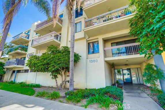 Front view of a multi-story residential building with balconies.