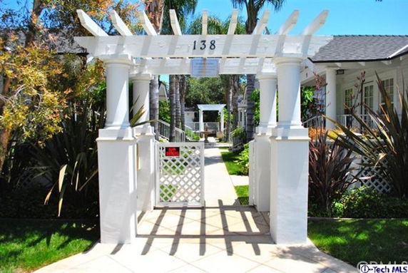 Front view of a house with a decorative entrance gate and columns.