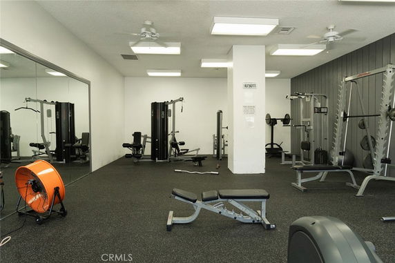 Indoor gym area with equipment and exercise machines.