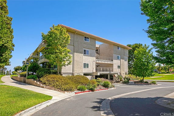 Front view of a multi-story residential building with balconies.