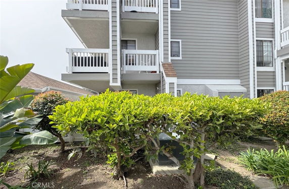 Front view of a multi-story building with multiple balconies.