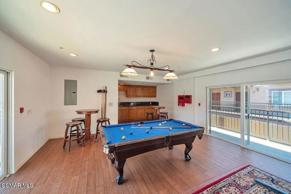 Room with a pool table and seating area.