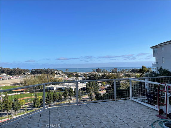 Wide angle view of surroundings with ocean in the background seen from a building.
