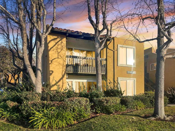 Front view of a two-story residential building with a balcony.