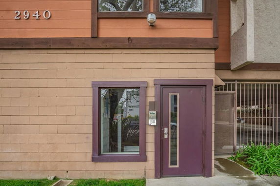 Front view of a building with a single entrance, window, and the numbers 2940 displayed.
