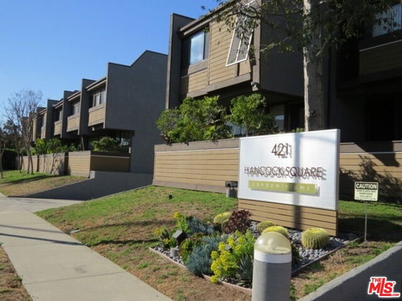 Front view of a multi-story condominium complex with a modern design.