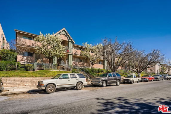 Front view of a two-story residential building with balconies.