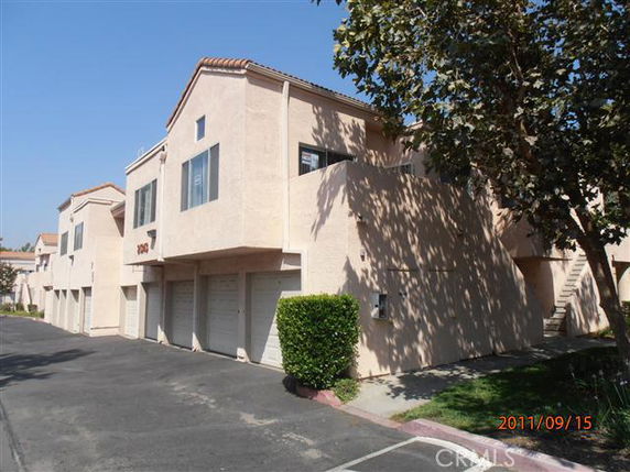 Front view of a two-story apartment building with garages.